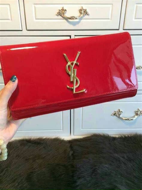 ysl patent leather fold over with zippers and removable strap|red ysl clutch.